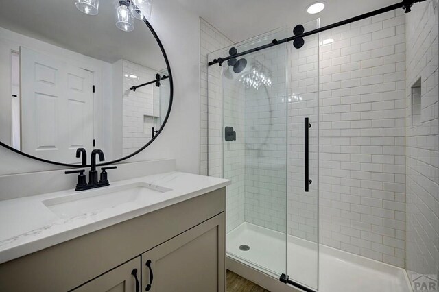 1436 Brewery Rd, Pueblo, CO 81001 - full bath with wood finished floors, vanity, and a stall shower