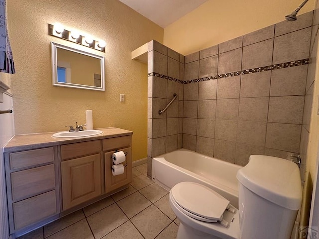 bathroom featuring a textured wall, bathtub / shower combination, toilet, vanity, and tile patterned floors