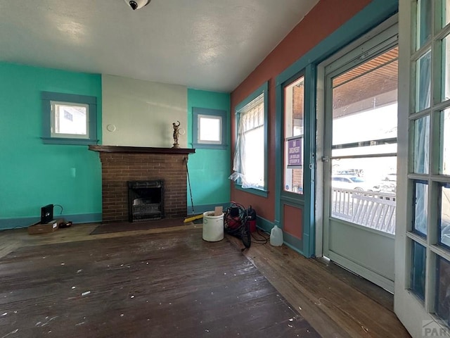 unfurnished living room featuring a fireplace and wood finished floors