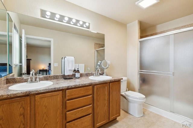 7470 Sun Prairie Dr, Fountain, CO 80925 - bathroom featuring a stall shower, double vanity, and tile patterned flooring
