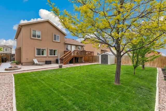 7470 Sun Prairie Dr, Fountain, CO 80925 - back of house with an outdoor fire pit, a storage shed, a fenced backyard, stairway, and a deck