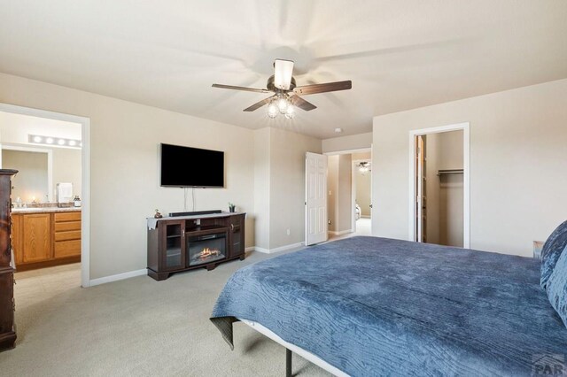 7470 Sun Prairie Dr, Fountain, CO 80925 - bedroom with light carpet, ceiling fan, ensuite bath, and a spacious closet