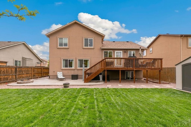 7470 Sun Prairie Dr, Fountain, CO 80925 - back of property featuring stairs, a deck, a patio area, a fenced backyard, and an outdoor fire pit