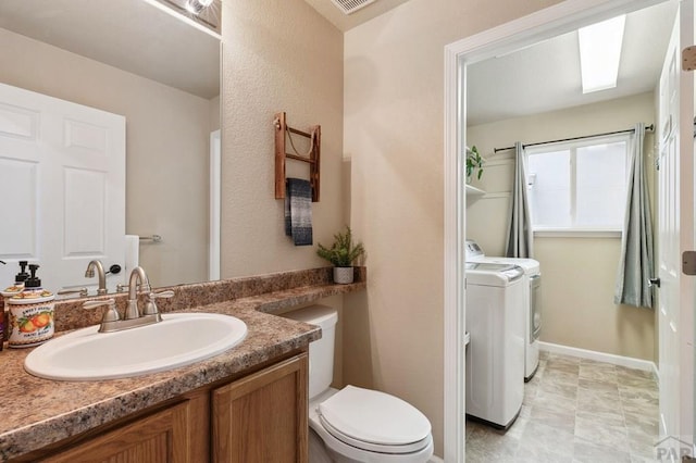 7470 Sun Prairie Dr, Fountain, CO 80925 - bathroom featuring washing machine and clothes dryer and vanity