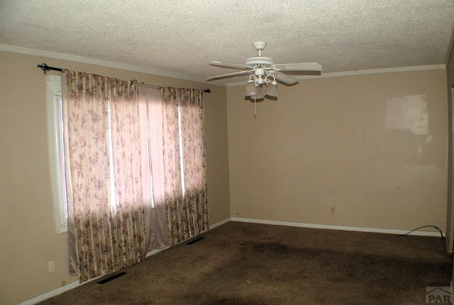 unfurnished room with plenty of natural light, a textured ceiling, visible vents, and carpet flooring