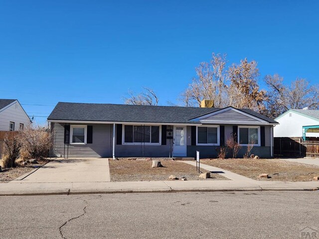 ranch-style house with fence