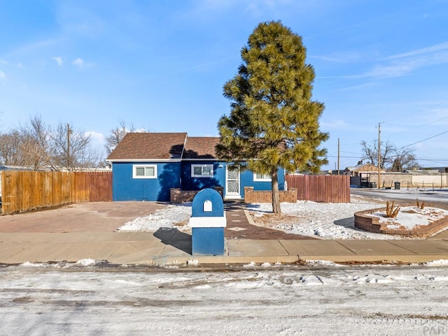 view of front of home featuring fence