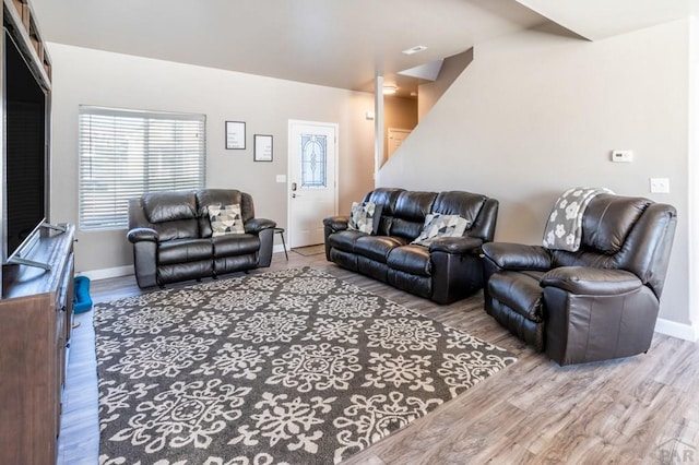 living area featuring wood finished floors and baseboards