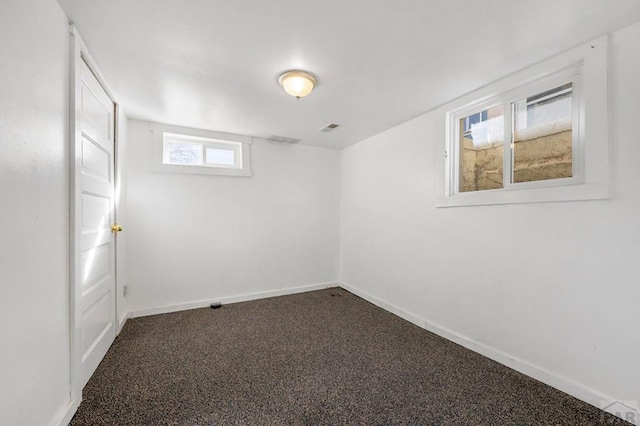 1609 Euclid Ave, Pueblo, CO 81004 - below grade area with baseboards, dark carpet, and visible vents