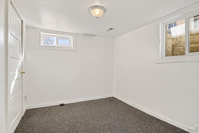 1609 Euclid Ave, Pueblo, CO 81004 - basement with baseboards, dark carpet, and visible vents