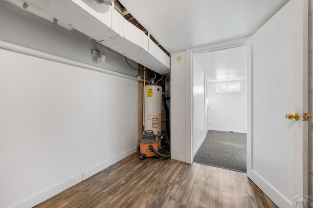 1609 Euclid Ave, Pueblo, CO 81004 - basement with baseboards, gas water heater, and wood finished floors