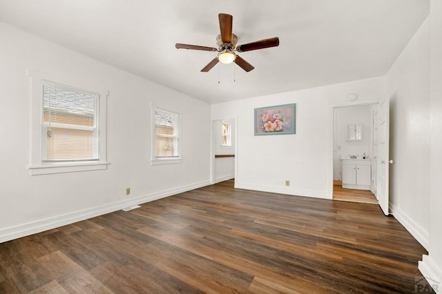 1609 Euclid Ave, Pueblo, CO 81004 - unfurnished bedroom with baseboards, a ceiling fan, and dark wood-style flooring