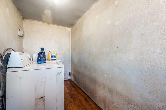 laundry room with dark wood-style floors and laundry area