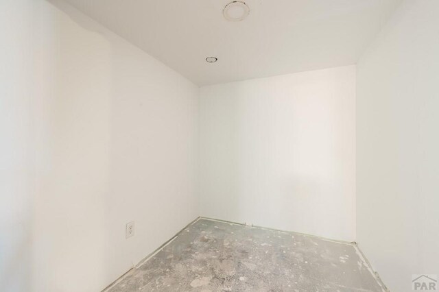 unfurnished room featuring unfinished concrete flooring