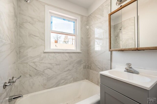 bathroom featuring shower / tub combination and vanity