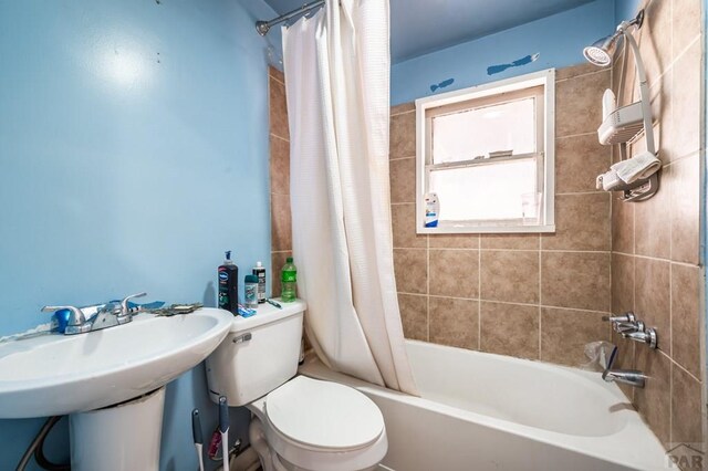 bathroom with shower / bath combo and toilet