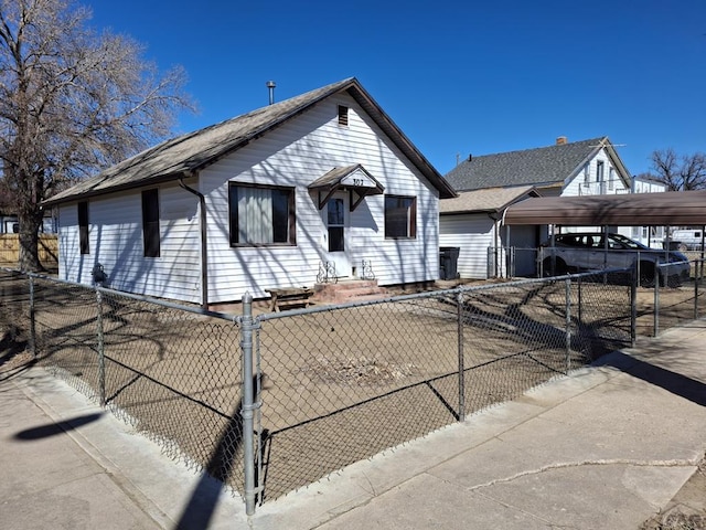 bungalow-style home with entry steps, a fenced front yard, and a gate