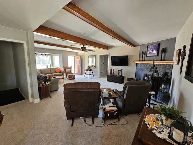 743 G St, Two Buttes, CO 81084 - carpeted living area with beamed ceiling, a ceiling fan, a stone fireplace, and baseboards