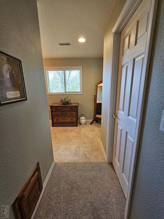743 G St, Two Buttes, CO 81084 - hall with light tile patterned floors, recessed lighting, baseboards, a textured wall, and light colored carpet