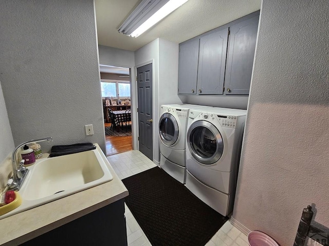 743 G St, Two Buttes, CO 81084 - clothes washing area with cabinet space, washer and dryer, a textured wall, and light floors