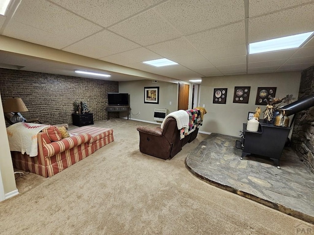 743 G St, Two Buttes, CO 81084 - carpeted living area featuring a drop ceiling, a wood stove, and heating unit