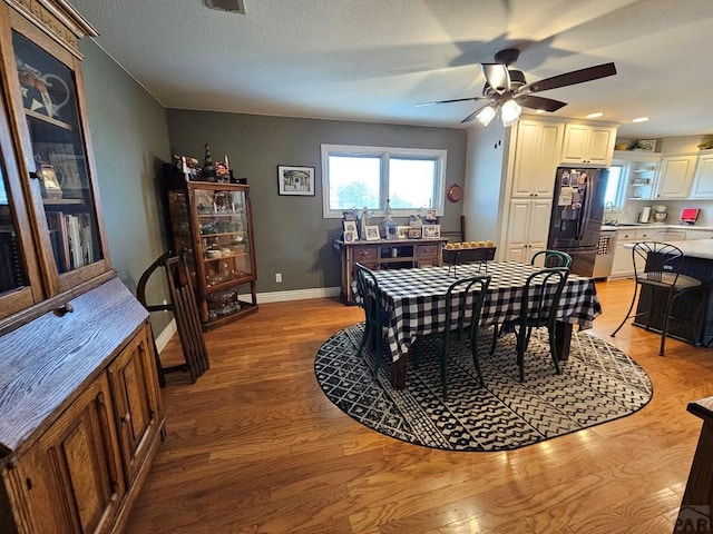 743 G St, Two Buttes, CO 81084 - dining space with light wood-type flooring, baseboards, ceiling fan, and recessed lighting