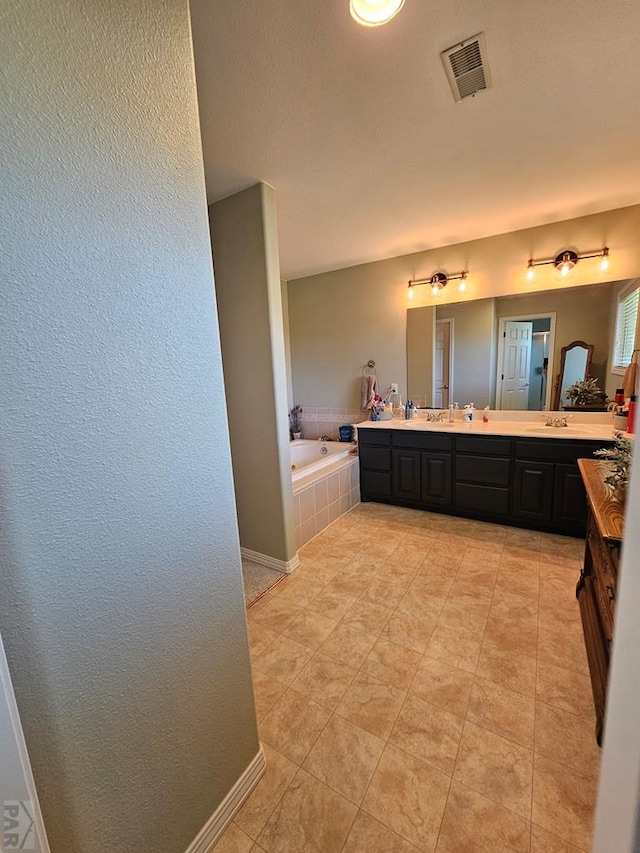 743 G St, Two Buttes, CO 81084 - full bath featuring a bath, vanity, a textured wall, baseboards, and tile patterned flooring