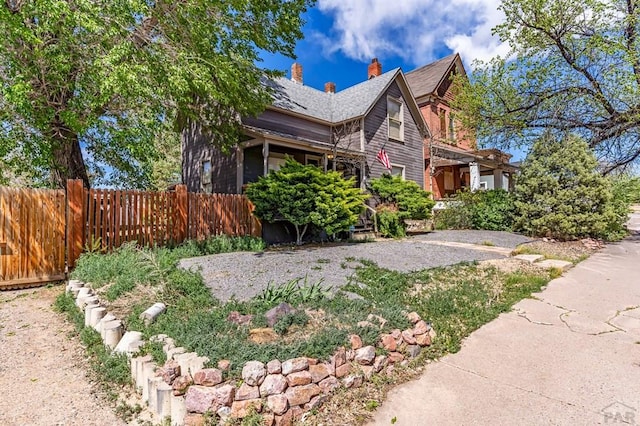 715 E 8th St, Pueblo, CO 81001 - view of side of home with fence and a chimney
