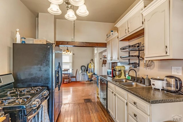 715 E 8th St, Pueblo, CO 81001 - kitchen featuring stainless steel gas stove, a chandelier, a sink, dark countertops, and dishwasher