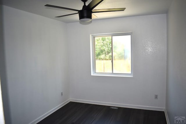 1417 Bradish Ave, La Junta, CO 81050 - spare room featuring dark wood finished floors, baseboards, and ceiling fan