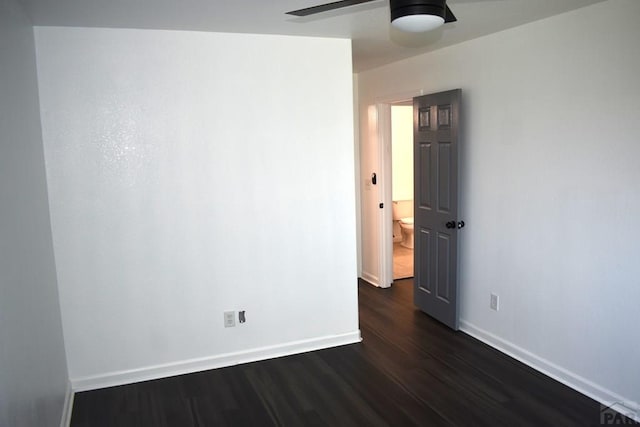 1417 Bradish Ave, La Junta, CO 81050 - empty room with dark wood-style flooring, a ceiling fan, and baseboards