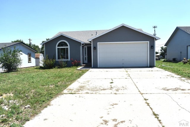 1417 Bradish Ave, La Junta, CO 81050 - ranch-style home with a front yard, a garage, and concrete driveway