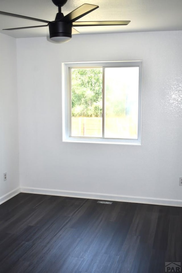 1417 Bradish Ave, La Junta, CO 81050 - unfurnished room featuring a ceiling fan, dark wood finished floors, and baseboards