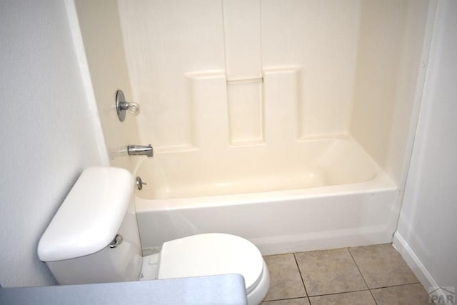 1417 Bradish Ave, La Junta, CO 81050 - bathroom with toilet, tile patterned flooring, and washtub / shower combination