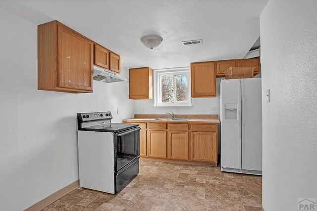 kitchen with light countertops, a textured ceiling, black appliances, a sink, and light tile patterned flooring