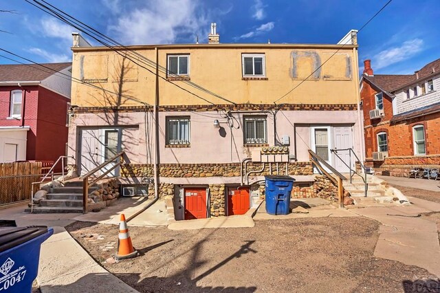 front of property with a balcony and stucco siding