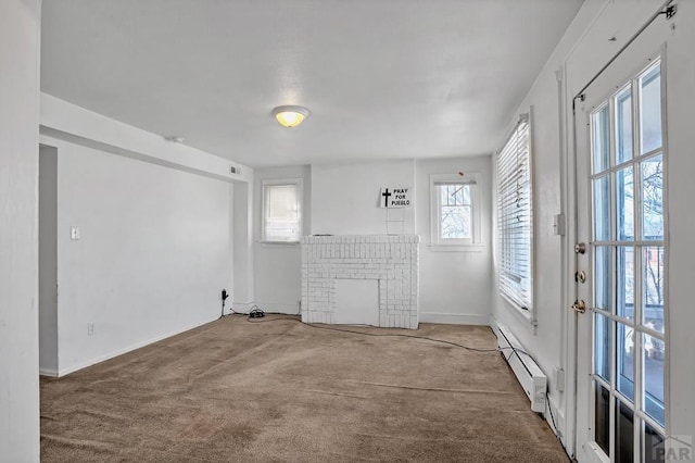 1110-112 E 6th St, Pueblo, CO 81001 - unfurnished living room with a baseboard radiator, carpet floors, baseboards, and a fireplace