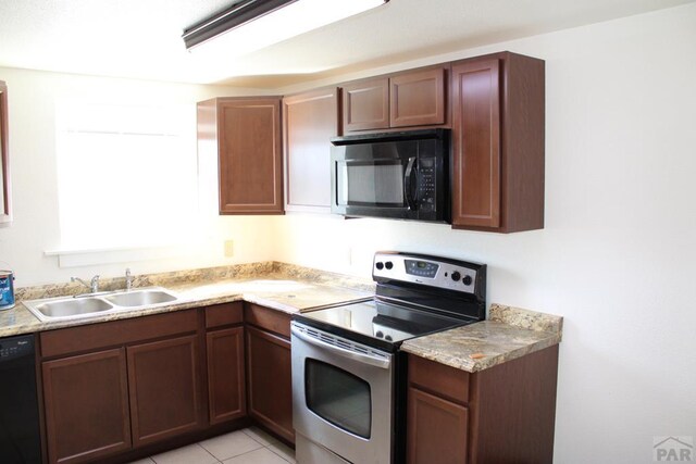 1110-112 E 6th St, Pueblo, CO 81001 - kitchen featuring light tile patterned flooring, black appliances, light countertops, and a sink