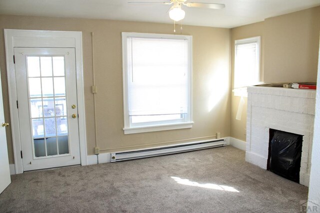 unfurnished living room featuring carpet floors, a baseboard radiator, a fireplace, and baseboards