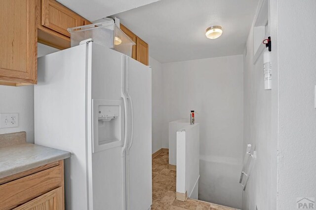 kitchen featuring black appliances, light tile patterned floors, light countertops, and a sink