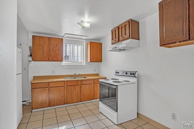 kitchen featuring light countertops, a sink, under cabinet range hood, and white range with electric cooktop