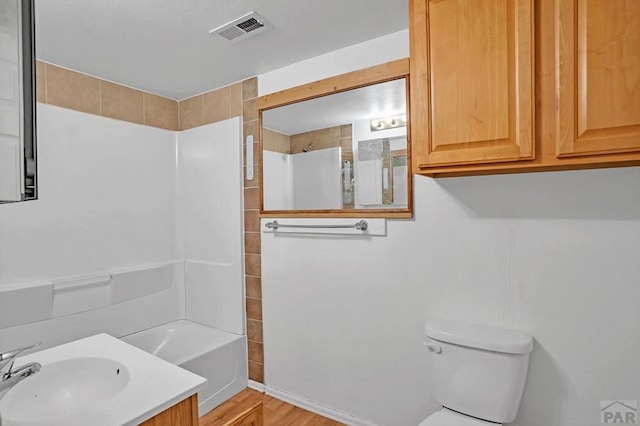1110-112 E 6th St, Pueblo, CO 81001 - bathroom featuring visible vents, toilet, wood finished floors, bathing tub / shower combination, and vanity