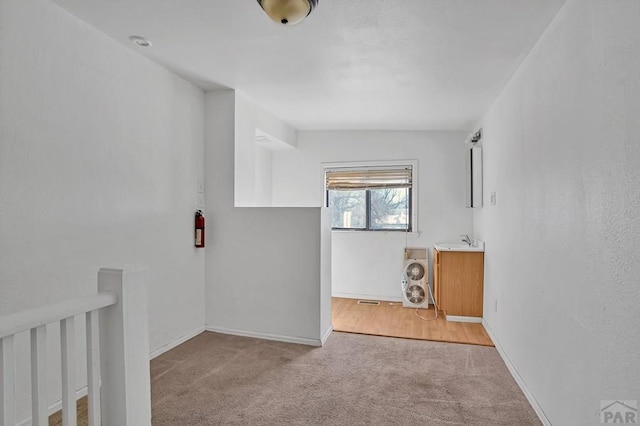 1110-112 E 6th St, Pueblo, CO 81001 - unfurnished room featuring light colored carpet, baseboards, and a sink