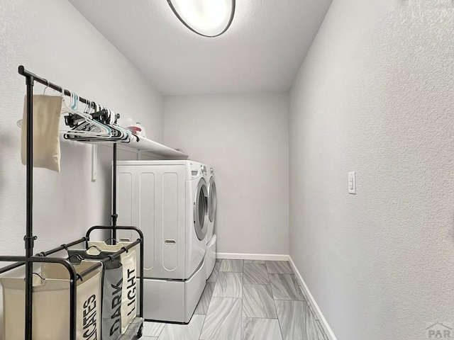 439 N Mitford Dr, Pueblo West, CO 81007 - laundry room featuring washing machine and dryer, baseboards, and light marble finish floors