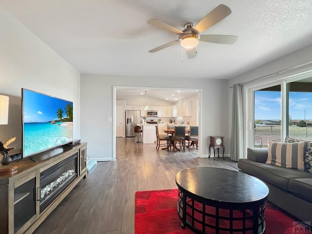 439 N Mitford Dr, Pueblo West, CO 81007 - living room with dark wood finished floors, baseboards, and ceiling fan