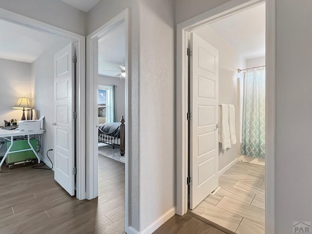 439 N Mitford Dr, Pueblo West, CO 81007 - corridor with wood finished floors and baseboards
