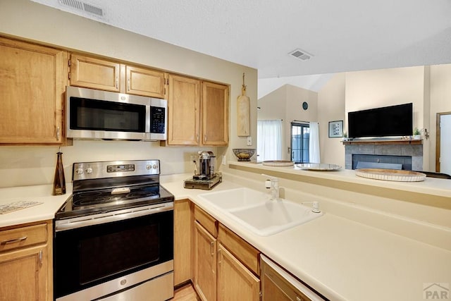 830 S Vance St, Lakewood, CO 80226 - kitchen with stainless steel appliances, a sink, light countertops, and open floor plan