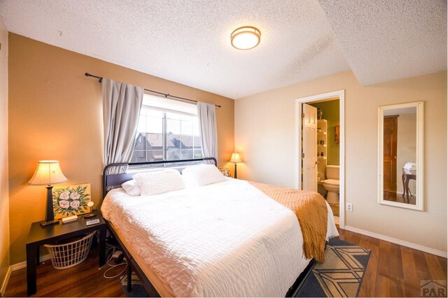 830 S Vance St, Lakewood, CO 80226 - bedroom featuring wood finished floors, a textured ceiling, baseboards, and ensuite bath