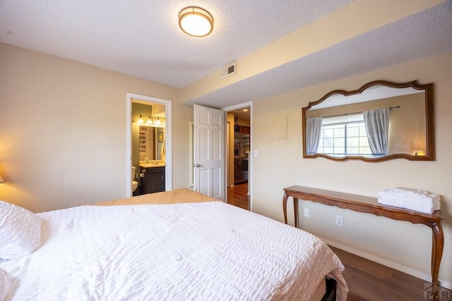 830 S Vance St, Lakewood, CO 80226 - bedroom with wood finished floors, connected bathroom, baseboards, and a textured ceiling