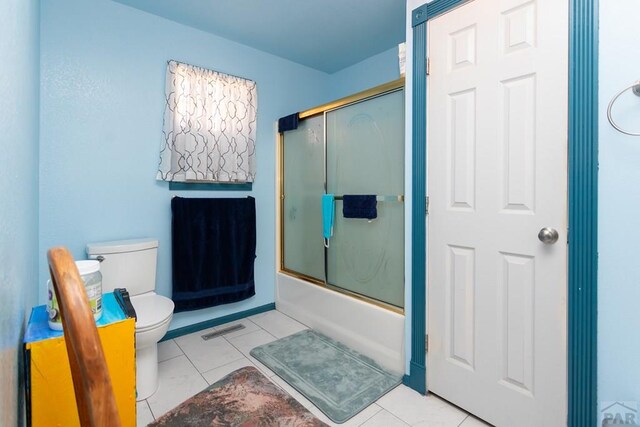 bathroom with toilet, shower / bath combination with glass door, visible vents, and tile patterned floors